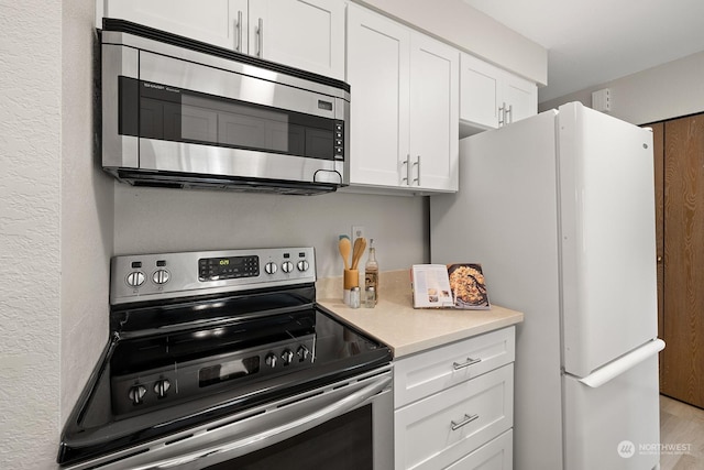 kitchen with white cabinetry and stainless steel appliances