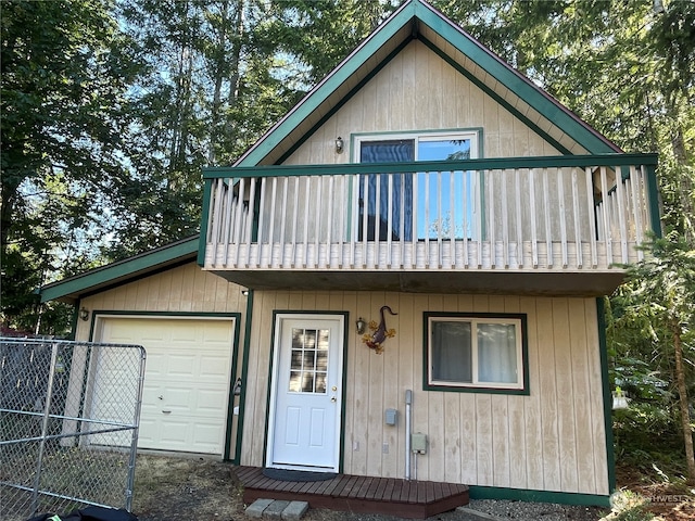 view of front of house featuring a garage and a balcony