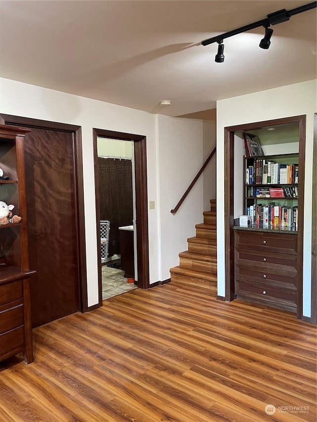 entryway with track lighting and hardwood / wood-style floors