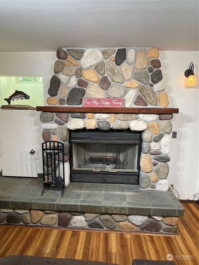 details featuring a stone fireplace and hardwood / wood-style floors