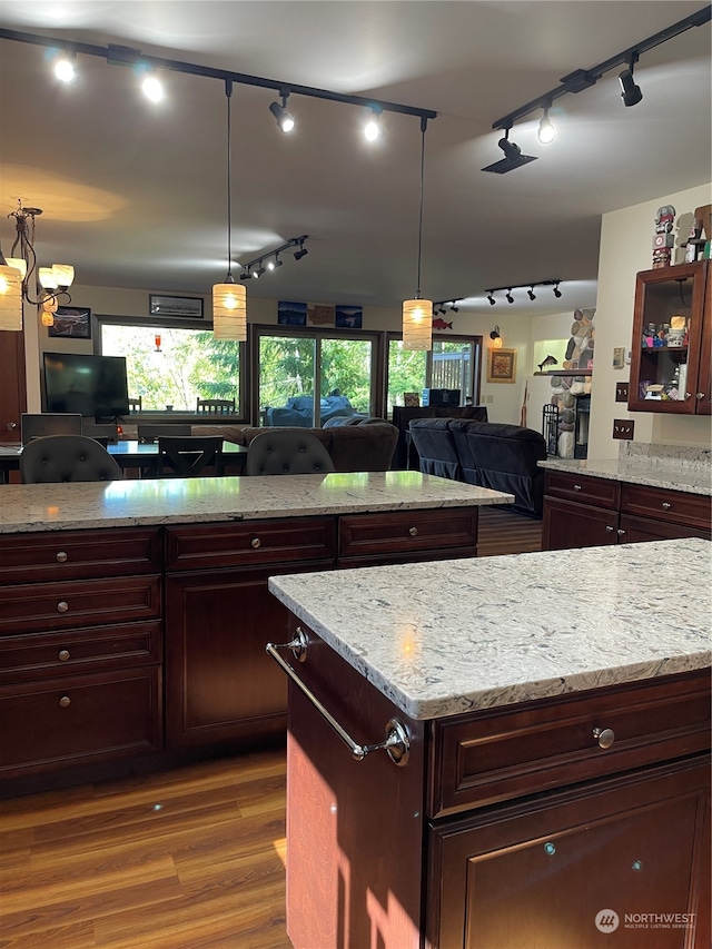 kitchen featuring hanging light fixtures, a wealth of natural light, and rail lighting