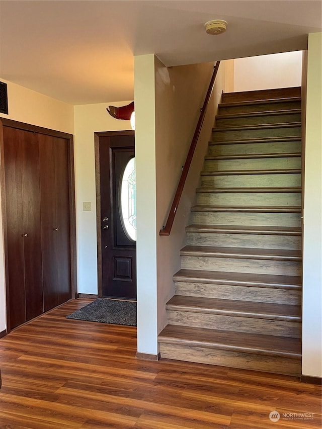 staircase with wood finished floors