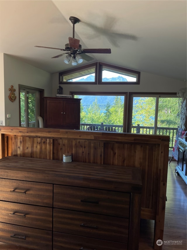 interior space with dark wood-type flooring, vaulted ceiling, and ceiling fan