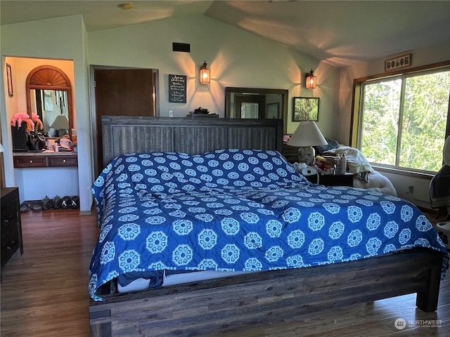 bedroom with dark hardwood / wood-style floors, ceiling fan, and lofted ceiling