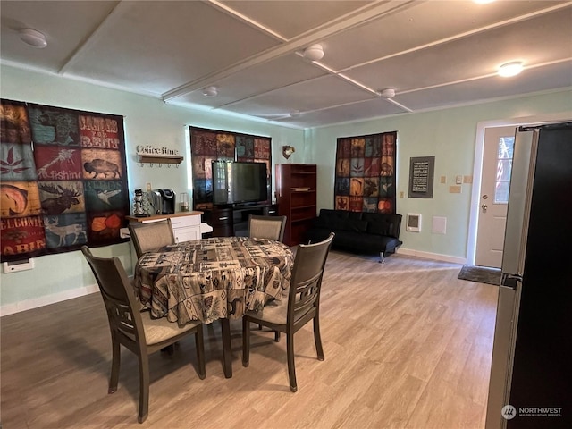 dining area featuring light wood-type flooring and baseboards