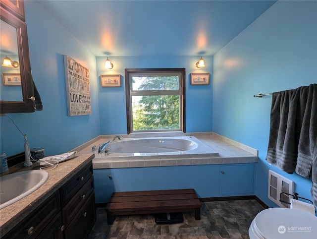 full bathroom with visible vents, toilet, vanity, and a bath