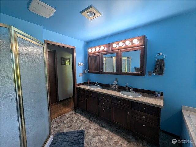 bathroom with plus walk in shower, wood-type flooring, and double vanity