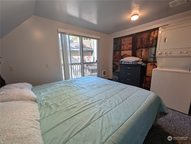 carpeted bedroom featuring access to outside, stacked washer and clothes dryer, and lofted ceiling