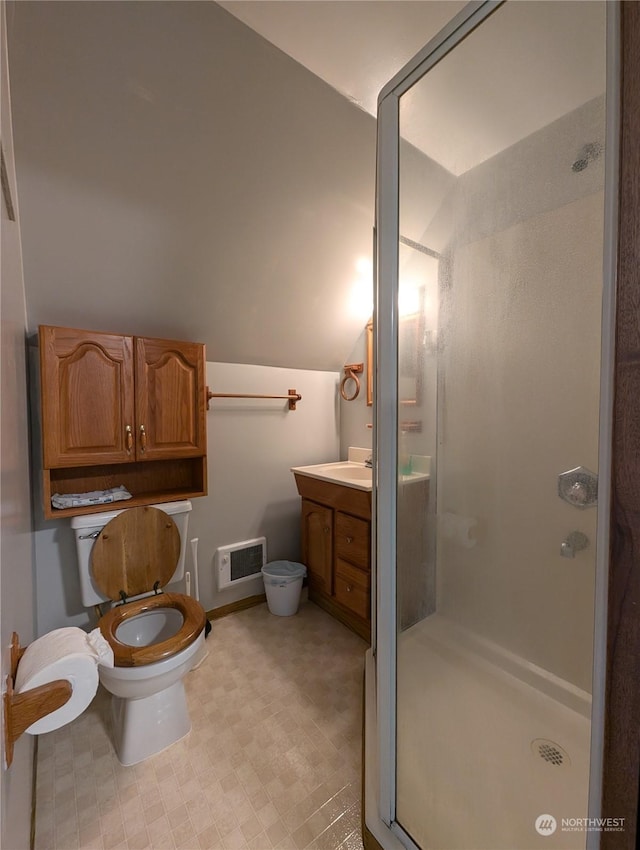 bathroom with lofted ceiling, toilet, visible vents, vanity, and a stall shower