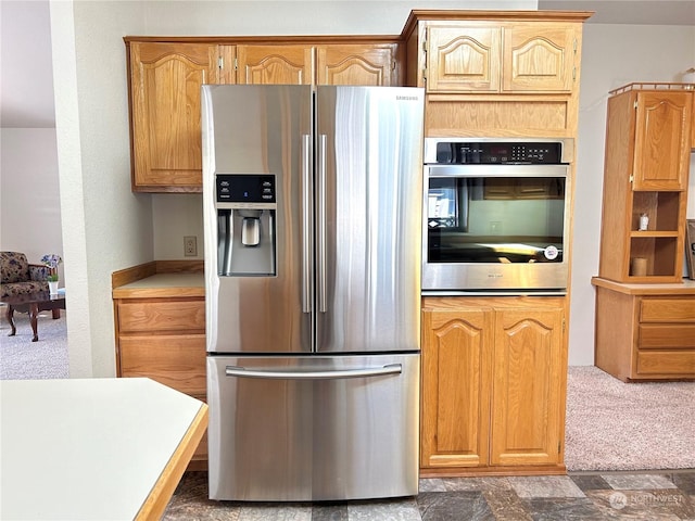 kitchen with stainless steel refrigerator with ice dispenser and dark colored carpet