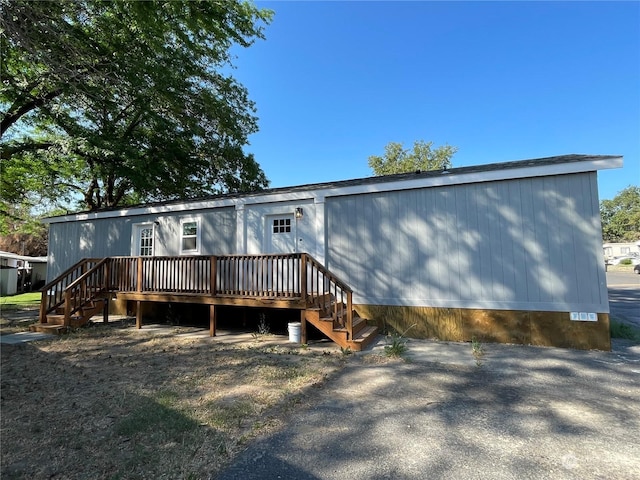 rear view of property with a wooden deck