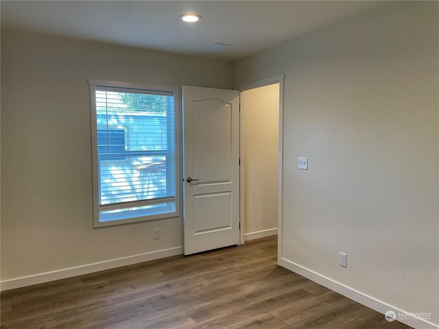 spare room featuring dark hardwood / wood-style flooring