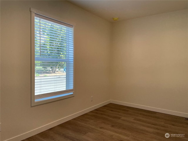 empty room with dark wood-type flooring