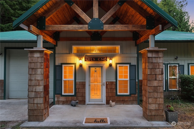 view of exterior entry at dusk