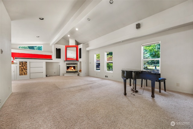 interior space with high vaulted ceiling, carpet, a wealth of natural light, and beam ceiling