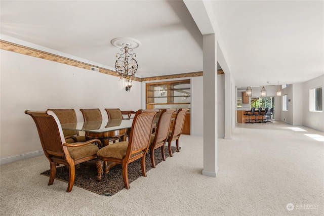 dining area with a chandelier and light carpet