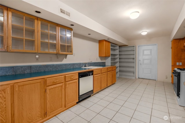 kitchen with dishwasher, sink, stove, and light tile patterned floors