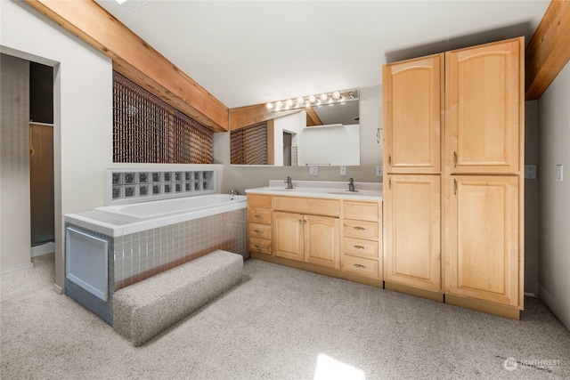 bathroom with vanity and tiled bath