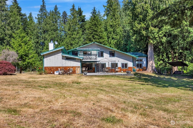 rear view of property with a lawn