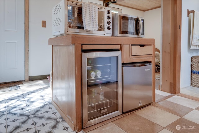 room details featuring crown molding, stainless steel appliances, and beverage cooler