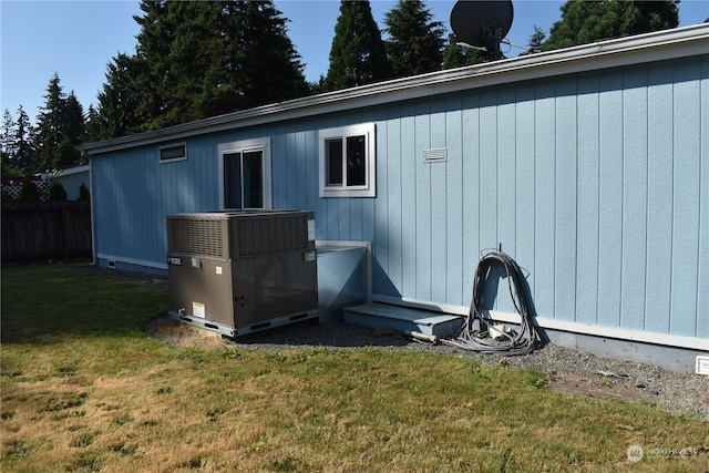 exterior space featuring cooling unit and a yard