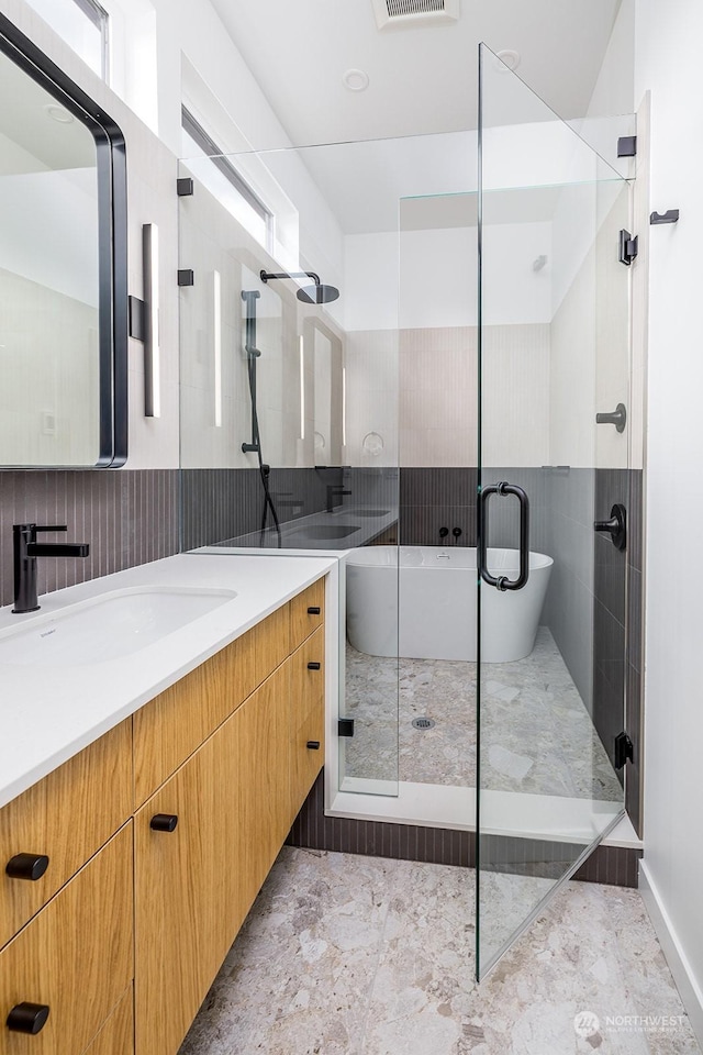 bathroom with vanity and plus walk in shower