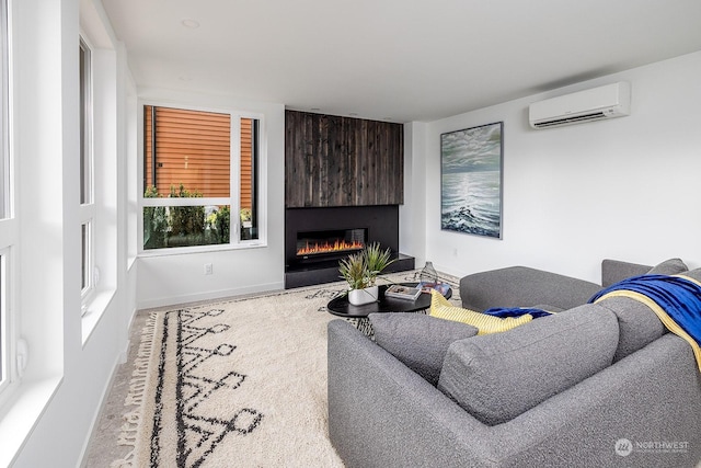 living room with a wall unit AC and a large fireplace