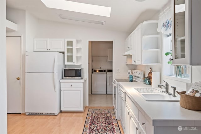 kitchen with light countertops, glass insert cabinets, white cabinetry, washer and dryer, and white appliances