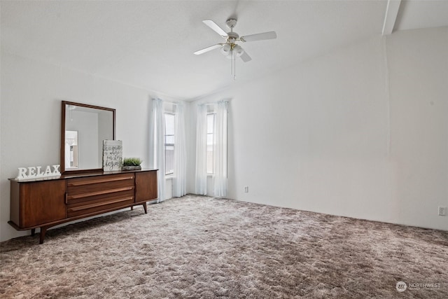 carpeted empty room featuring lofted ceiling and ceiling fan