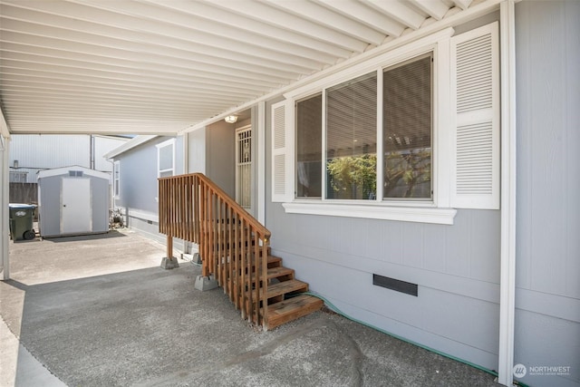 view of patio / terrace featuring an attached carport and a storage shed