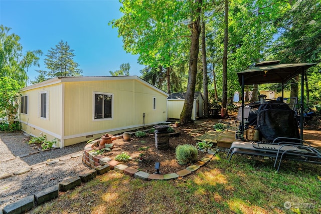 view of yard with a gazebo, an outdoor structure, and a wooden deck