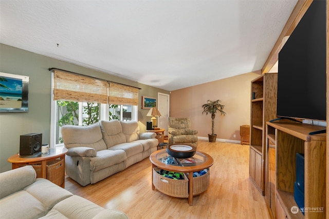 living room with light wood-style flooring and baseboards