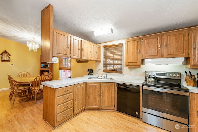 kitchen featuring under cabinet range hood, a peninsula, a sink, black dishwasher, and electric stove