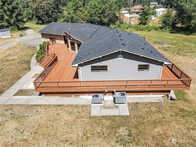 back of property featuring central AC unit, a patio, a deck, and a lawn