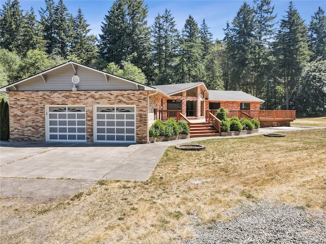 ranch-style home with a garage, a wooden deck, and a front yard