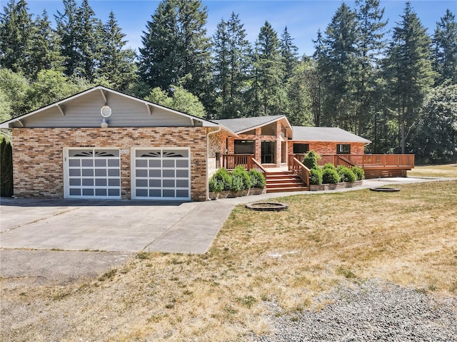 34210 206th Ave SE, Auburn, WA 98092 - view of front of house with concrete driveway, a garage, brick siding, and a front yard