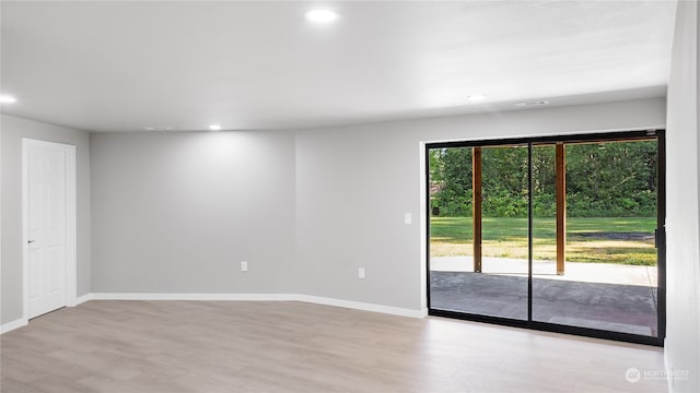 spare room featuring light hardwood / wood-style flooring