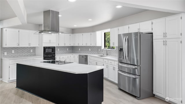 kitchen featuring white cabinetry, light hardwood / wood-style flooring, black appliances, and island exhaust hood