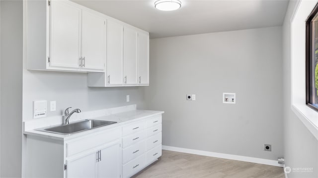 kitchen featuring white cabinetry, light hardwood / wood-style floors, and sink