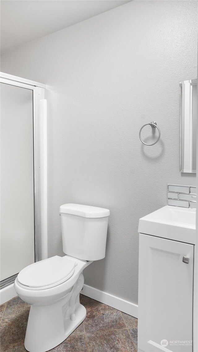 34210 206th Ave SE, Auburn, WA 98092 - full bathroom featuring vanity, toilet, baseboards, and a shower stall