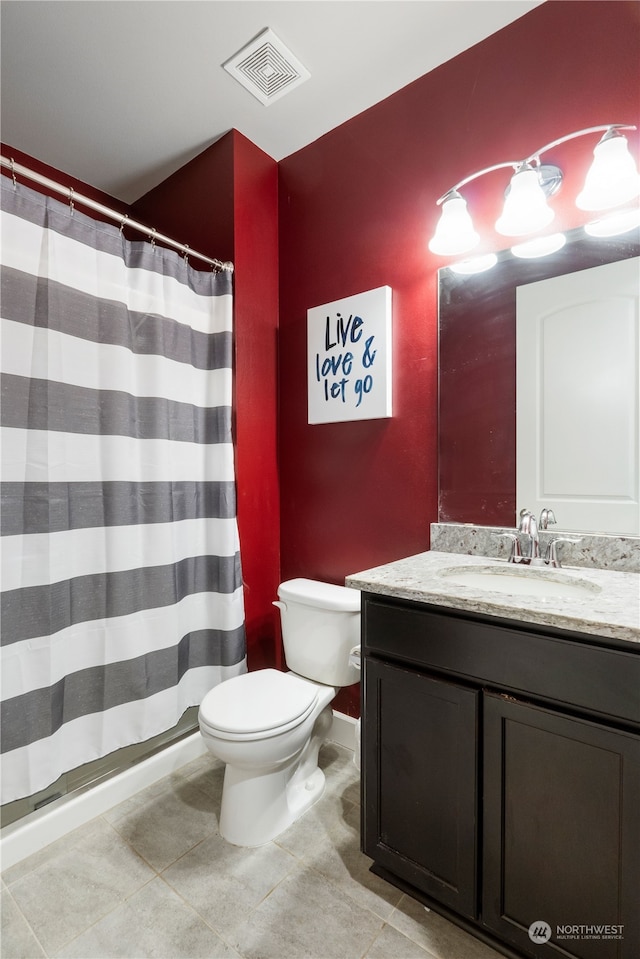 bathroom with vanity, tile patterned flooring, and toilet