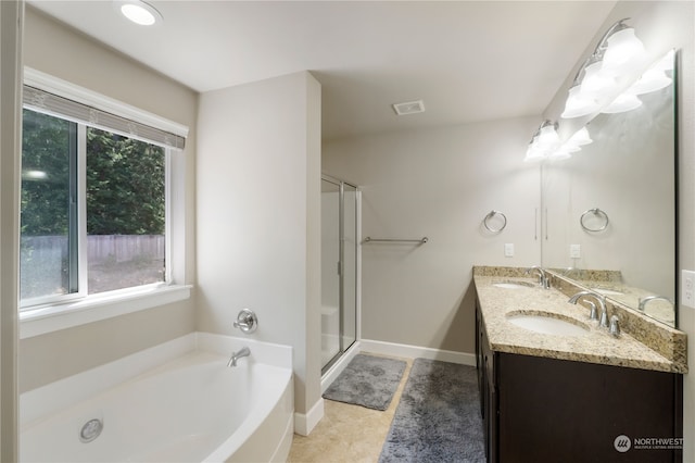 bathroom with plus walk in shower, tile patterned floors, and dual bowl vanity