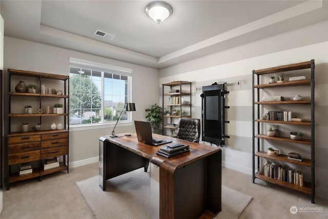 office with light carpet and a raised ceiling