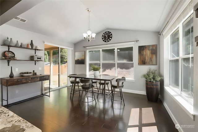 dining room featuring dark hardwood / wood-style flooring, vaulted ceiling, and a chandelier