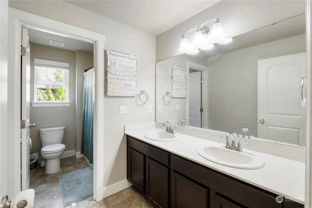 bathroom with toilet, tile patterned floors, and dual bowl vanity