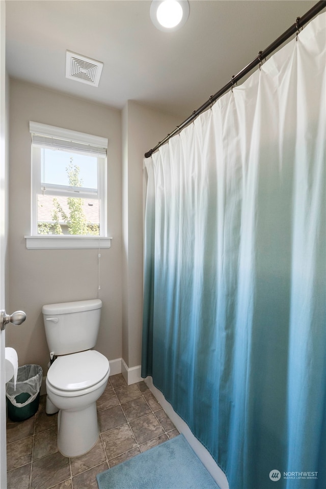 bathroom featuring tile patterned flooring and toilet