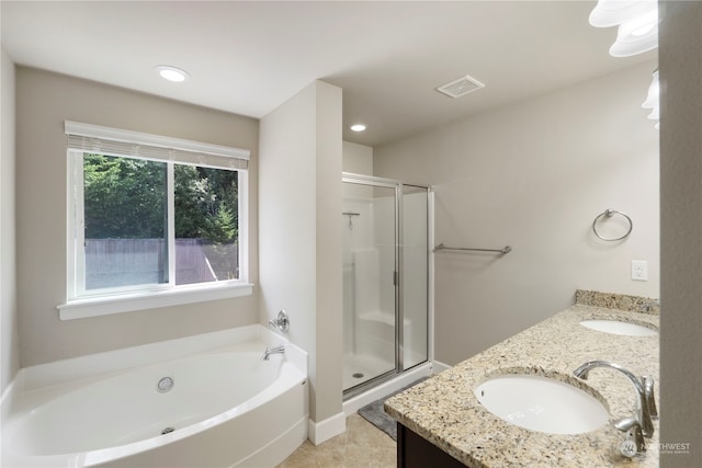 bathroom with dual vanity, shower with separate bathtub, and tile patterned flooring