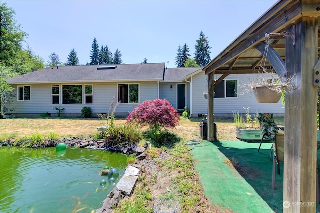 rear view of house with a gazebo and a lawn