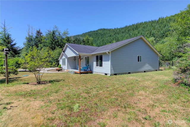 view of side of property with a lawn