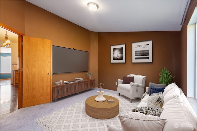 carpeted living room featuring vaulted ceiling